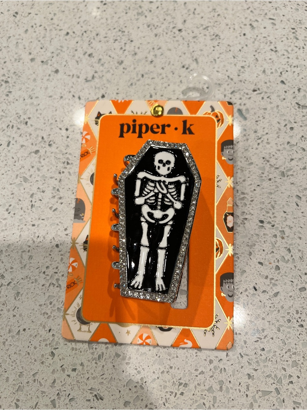 Piper K white skeleton in a coffin hair clip with glittery silver